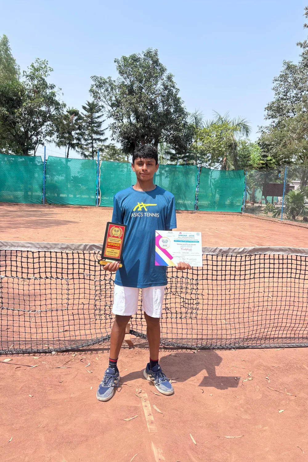 Sparsh with his trophy for winning the doubles category at the NS Jalandhar U-14 Tennis Tournament, Punjab