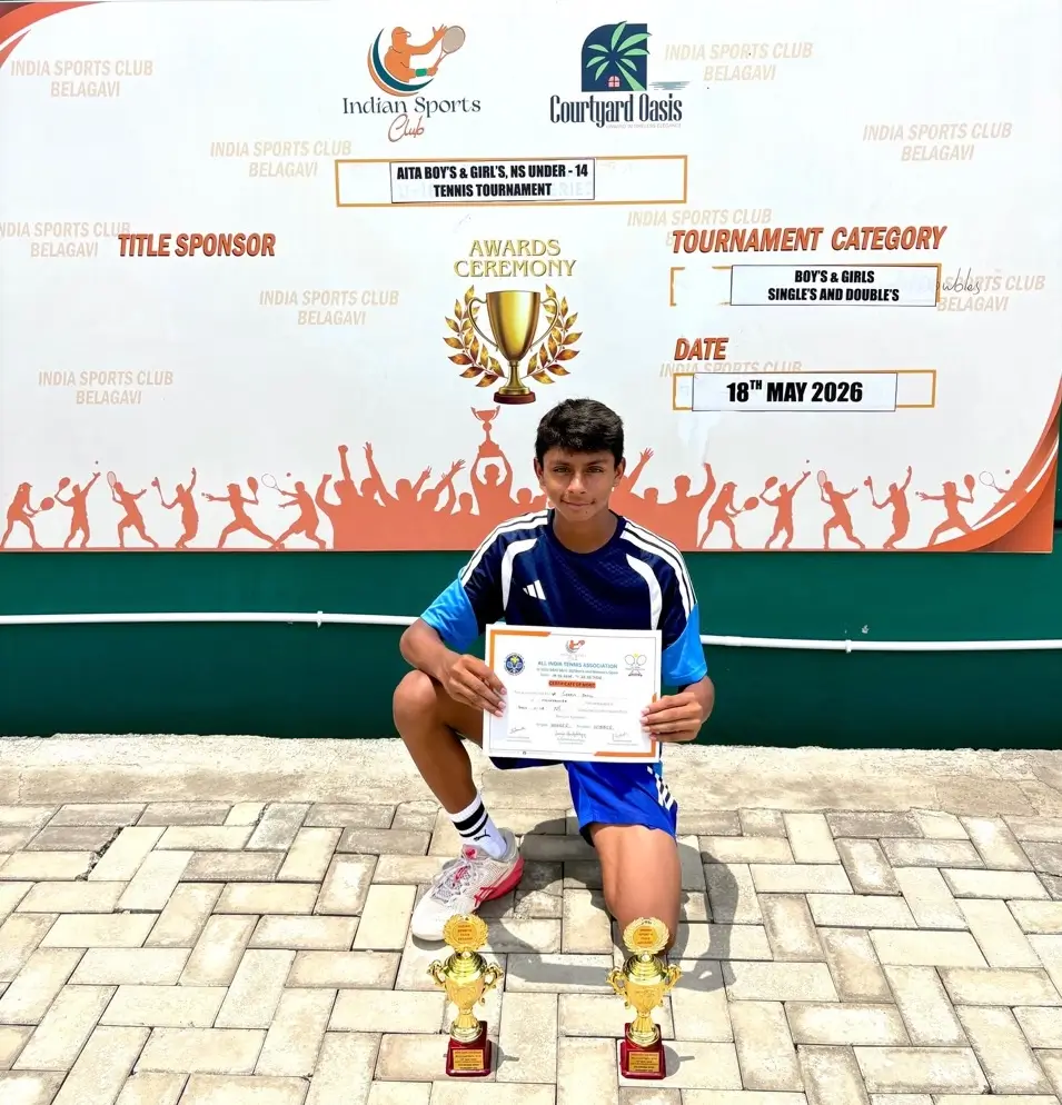 Sparsh receiving trophy for winning the singles and doubles categories at NS Belagavi U-14 Tennis Tournament
